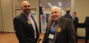 Joe Kormos, right speaking to Troy McLellan, left